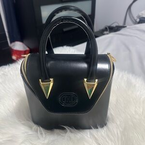 Chic Black Handbag with Gold Accents